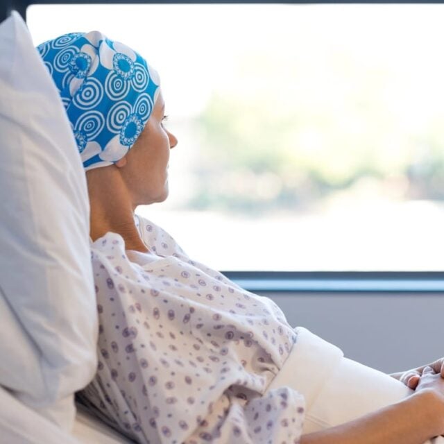 woman in hospital bed looking out the window
