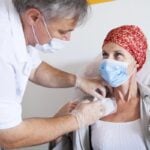 doctor adjusting implanted port device